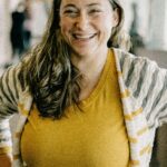 Confident woman in yellow at a business conference, Kansas City, Missouri.