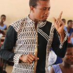 Engaging teacher in a vibrant classroom setting in Ghana. Inspiring education.